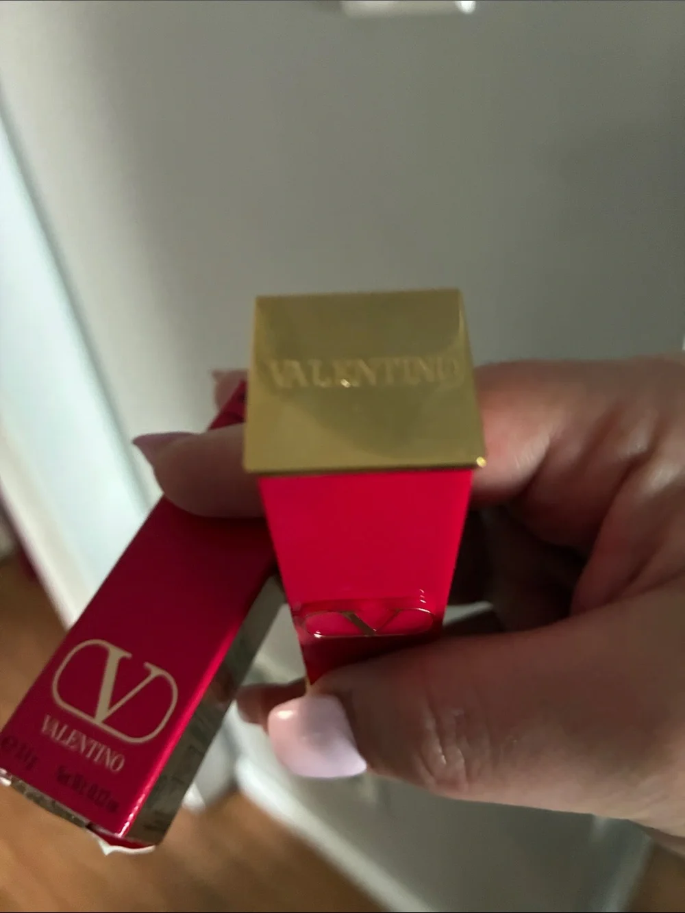 Valentino red lipstick with gold V-logo hardware